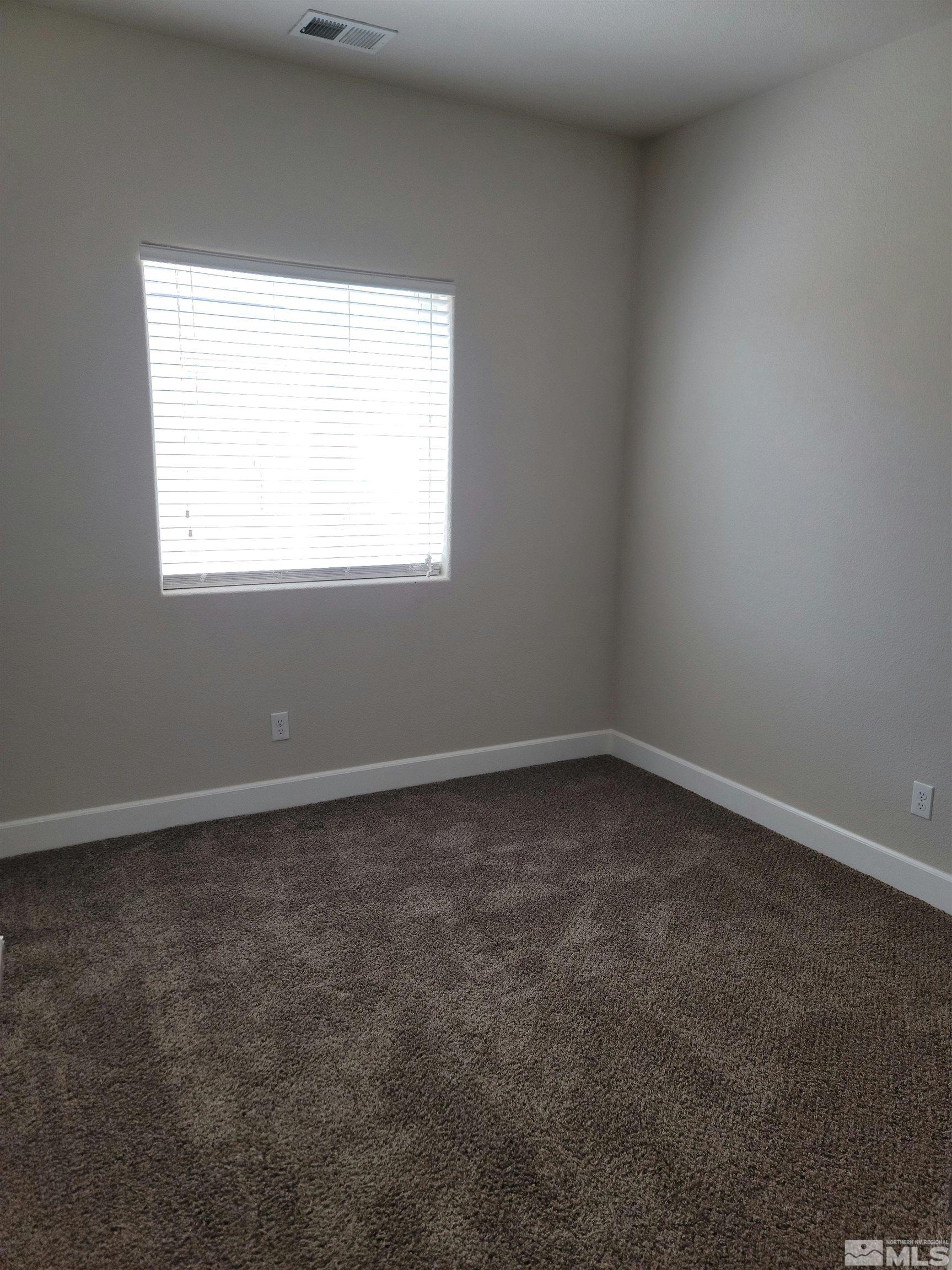 591 White Eagle Lane Fernley, NV 89408 - Photo 11 of 22 an empty room with a window