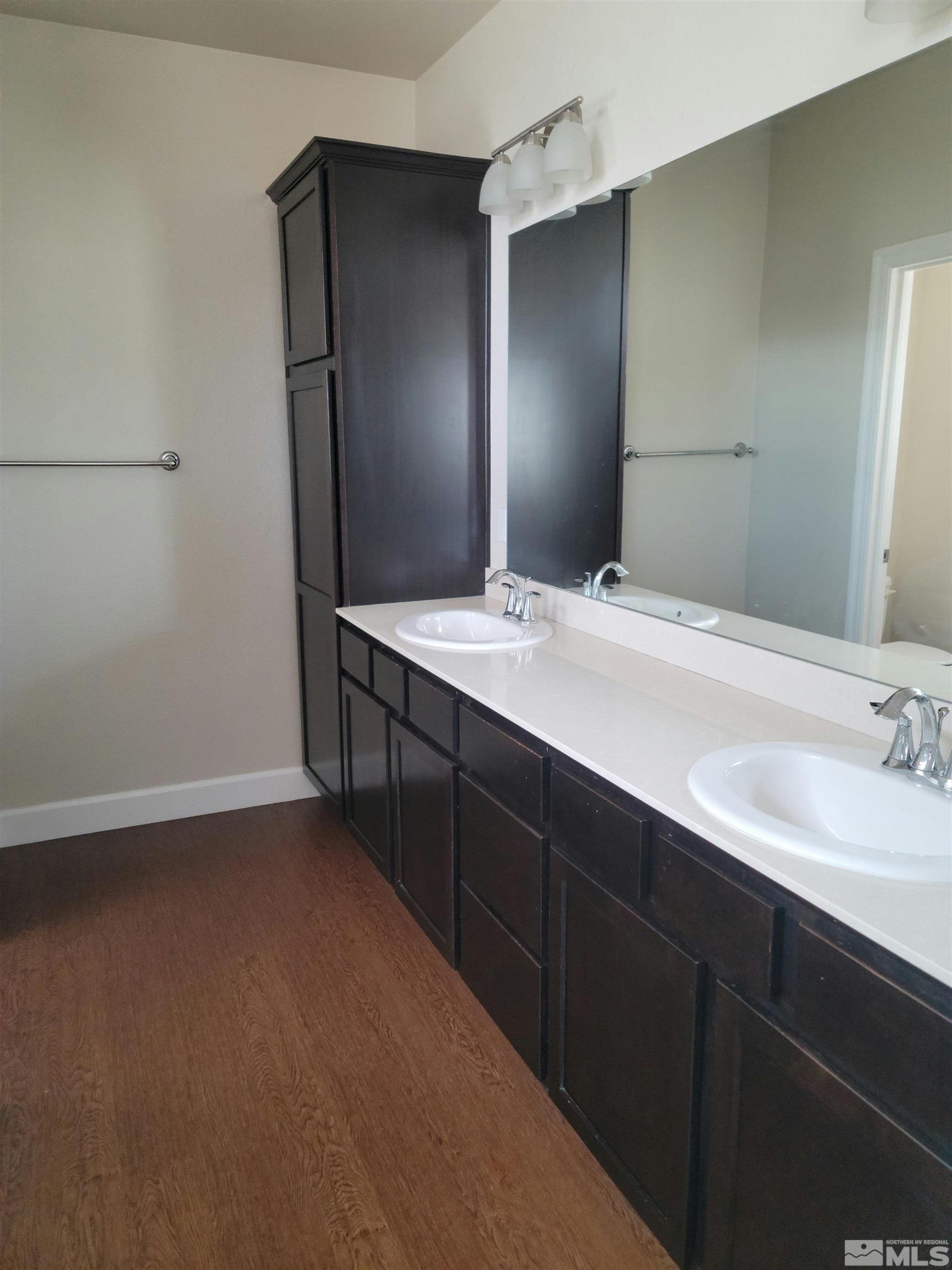 591 White Eagle Lane Fernley, NV 89408 - Photo 20 of 22 a bathroom with a double vanity sink and mirror