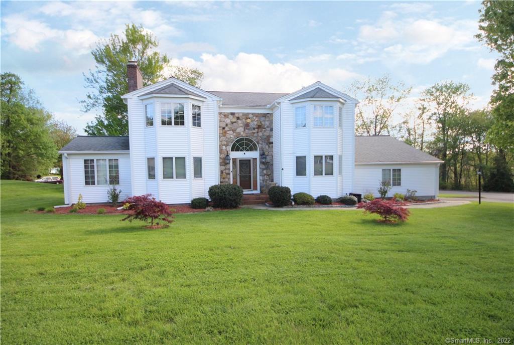 a front view of a house with a garden and porch
