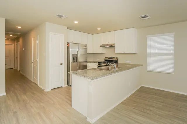 a view of kitchen with wooden floor