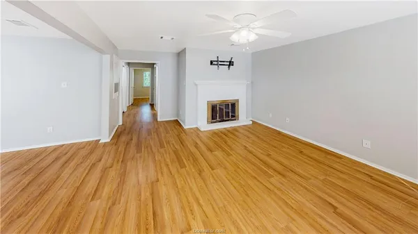wooden floor in an empty room with a fireplace