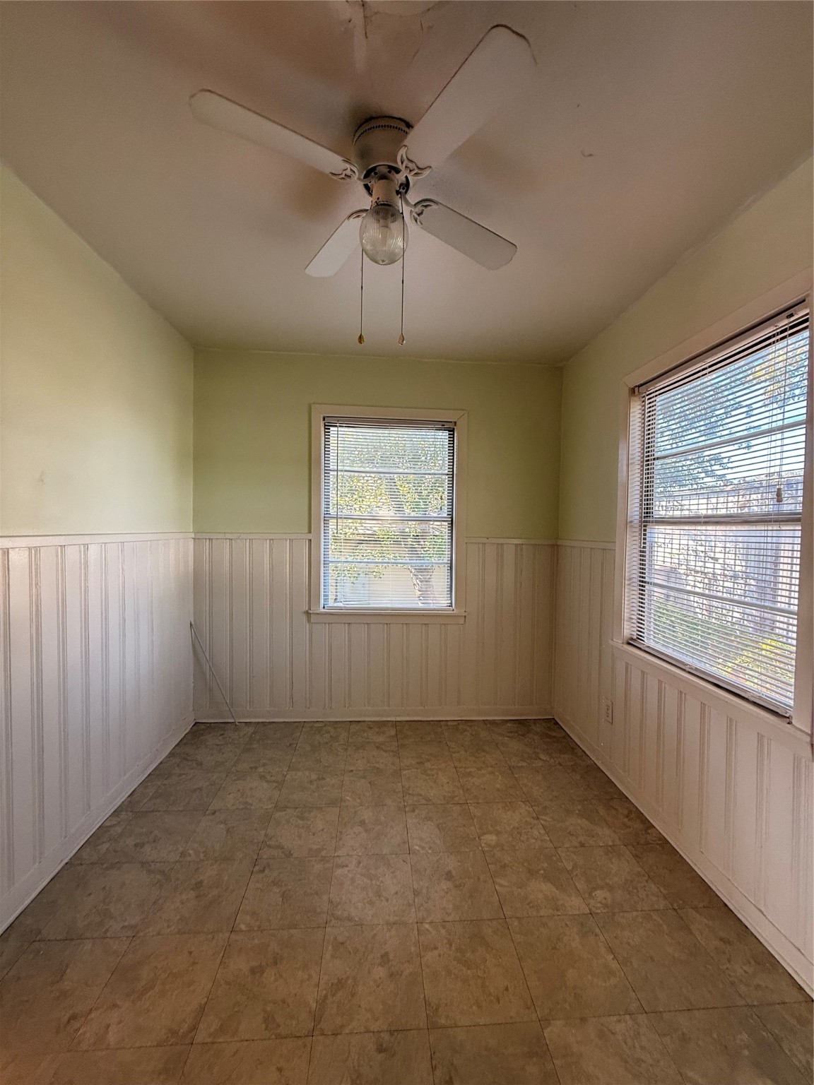 5724 1/2 Parwill Street Houston, TX 77081 - Photo 4 of 14 an empty room with a empty space and windows