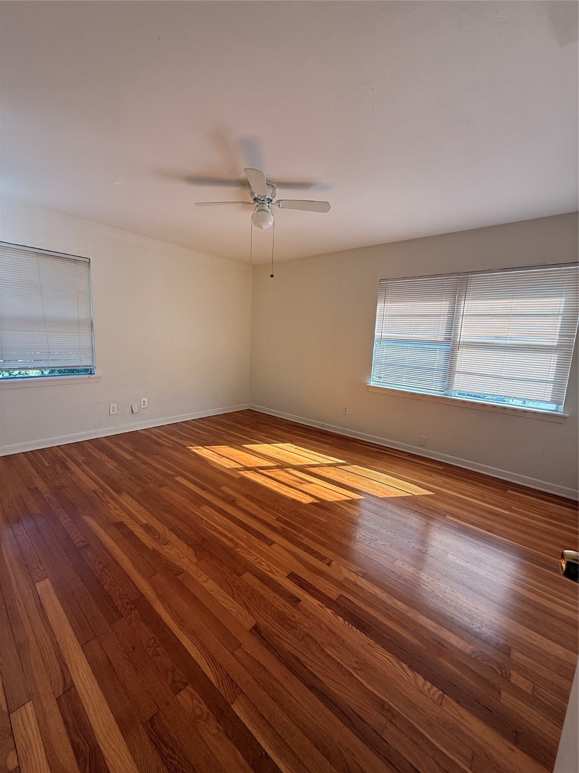5724 1/2 Parwill Street Houston, TX 77081 - Photo 5 of 14 a view of empty room with wooden floor and fan