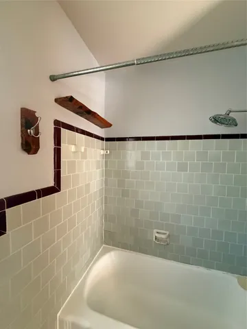 a bathroom with a shower and a sink