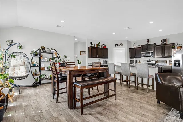 a view of a dining room with furniture and wooden floor