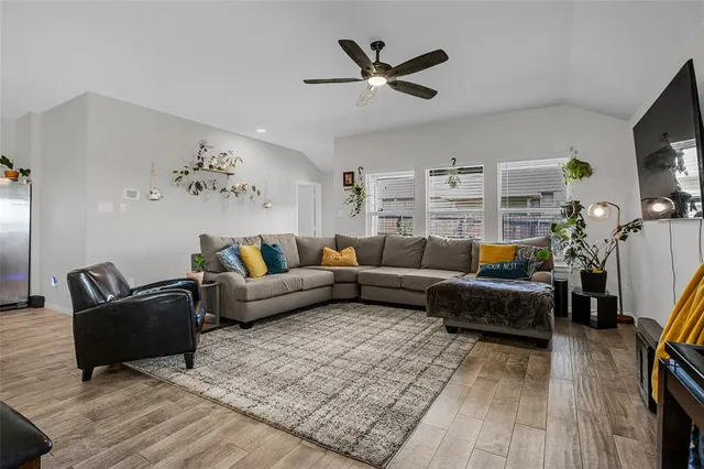 a living room with furniture and wooden floor