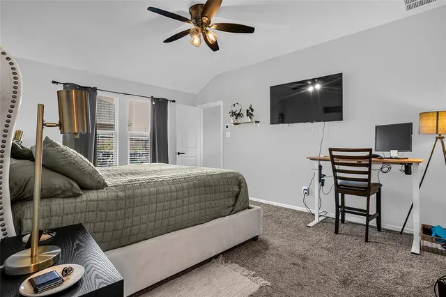 a bedroom with a bed and a television