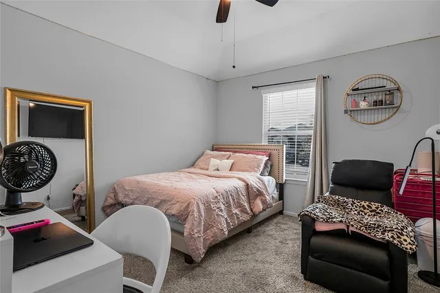 a bedroom with bed and a couch