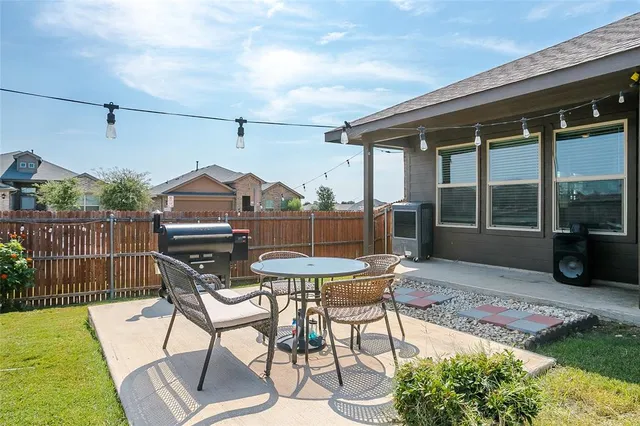 a view of a patio with a table and chairs