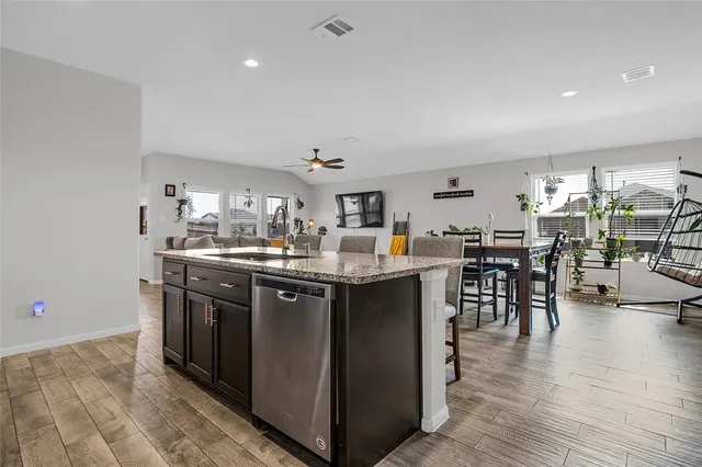 a kitchen with stainless steel appliances granite countertop a stove and a sink