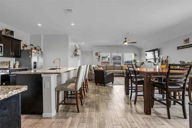 a view of a dining room with furniture and wooden floor