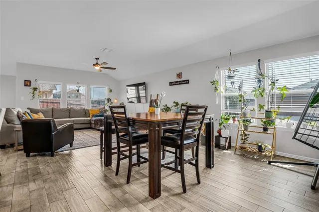 a view of a dining room with furniture and wooden floor