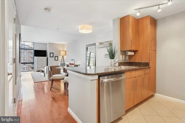 a kitchen with stainless steel appliances granite countertop a stove and a refrigerator