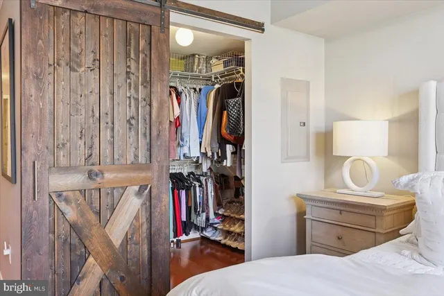 a bedroom with a bed and a mirror