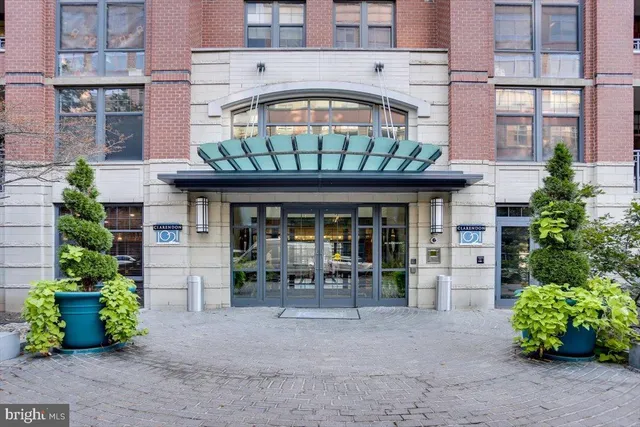 front view of a brick building with a bench