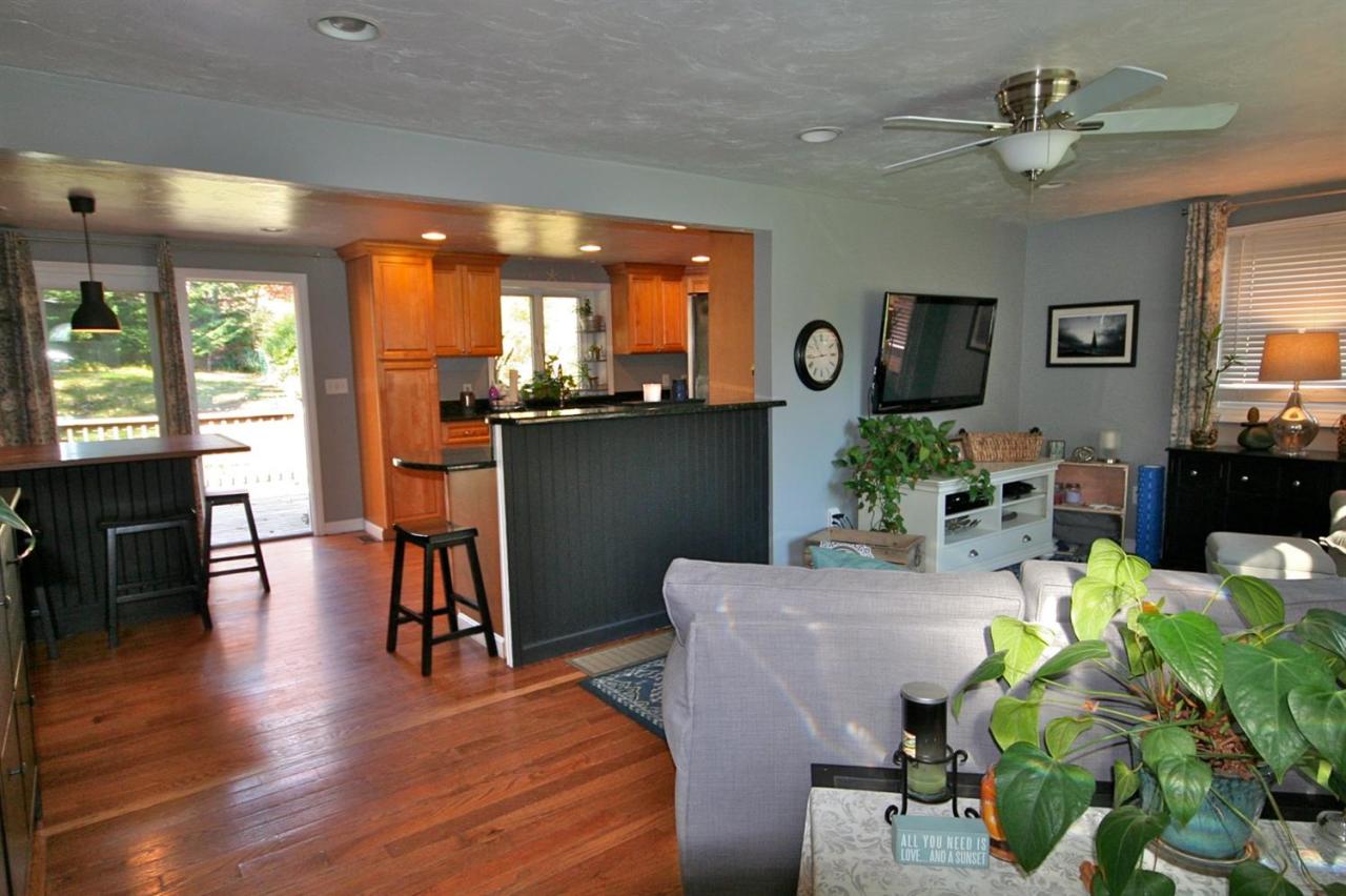 6 Albert Road Pocasset, MA 02559 - Photo 4 of 15 a dining room with furniture potted plants and wooden floor