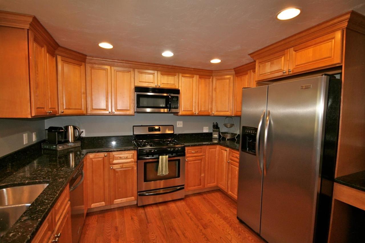 6 Albert Road Pocasset, MA 02559 - Photo 6 of 15 a kitchen with stainless steel appliances granite countertop a refrigerator a stove top oven a sink and dishwasher
