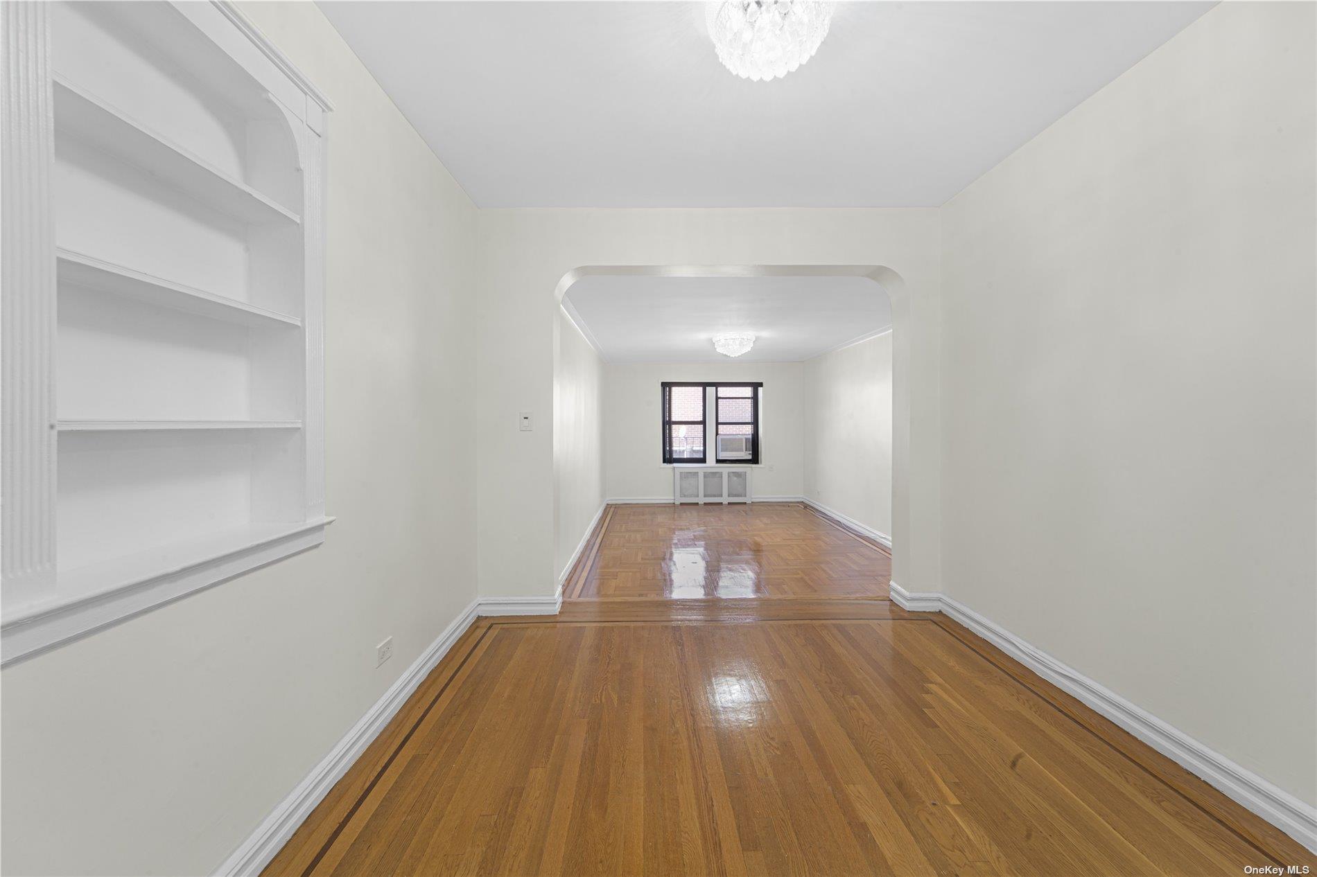 96-11 65th Road, Unit 414 Queens, NY 11374 - Photo 5 of 20 a view of a room with wooden floor and window