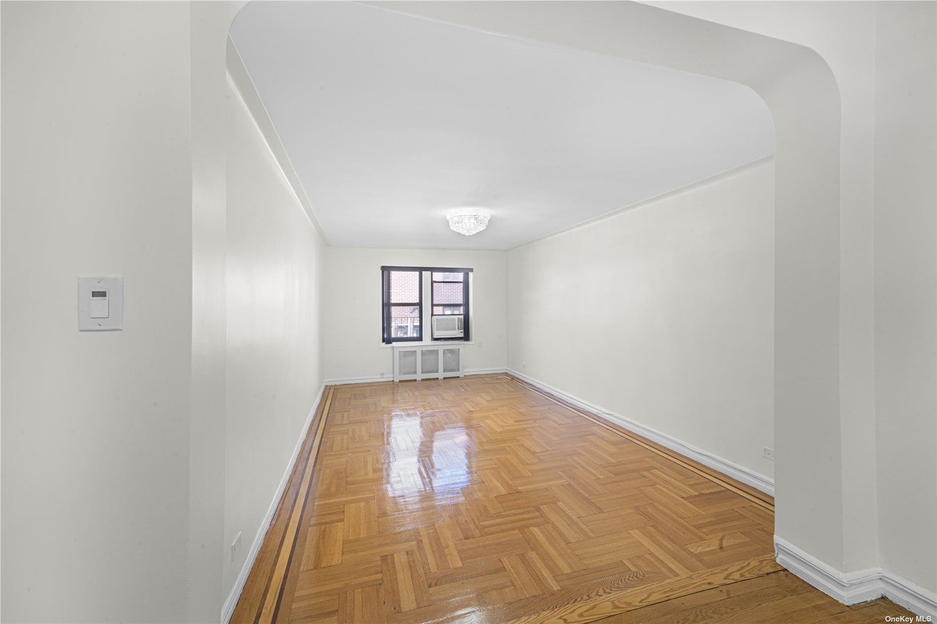 96-11 65th Road, Unit 414 Queens, NY 11374 - Photo 6 of 20 an empty room with windows