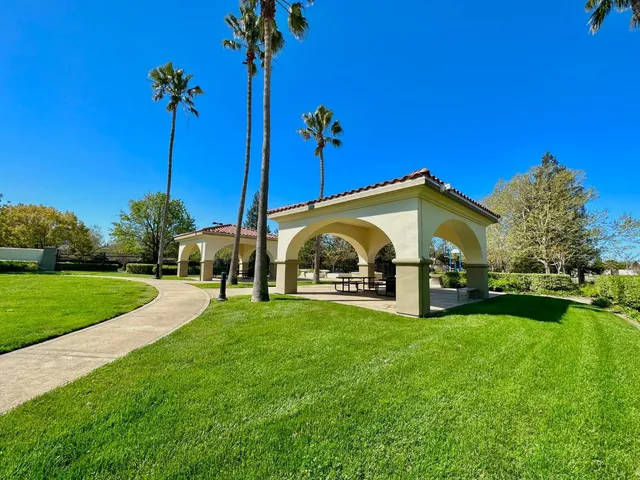 a balcony with outdoor seating and trees