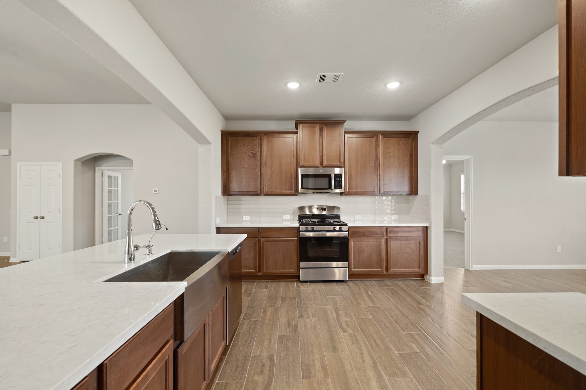 6010 Kolle Drive Rosenberg, TX 77471 - Photo 13 of 45 a kitchen with stainless steel appliances granite countertop a sink stove and refrigerator