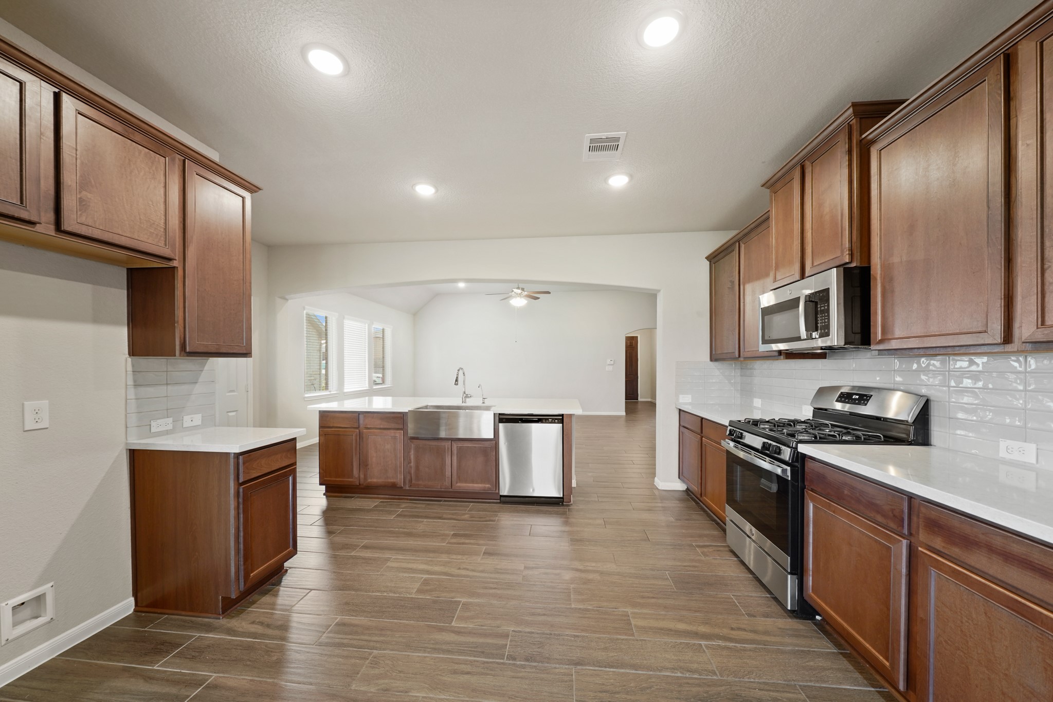 6010 Kolle Drive Rosenberg, TX 77471 - Photo 14 of 45 a large kitchen with stainless steel appliances lots of counter space and wooden floor
