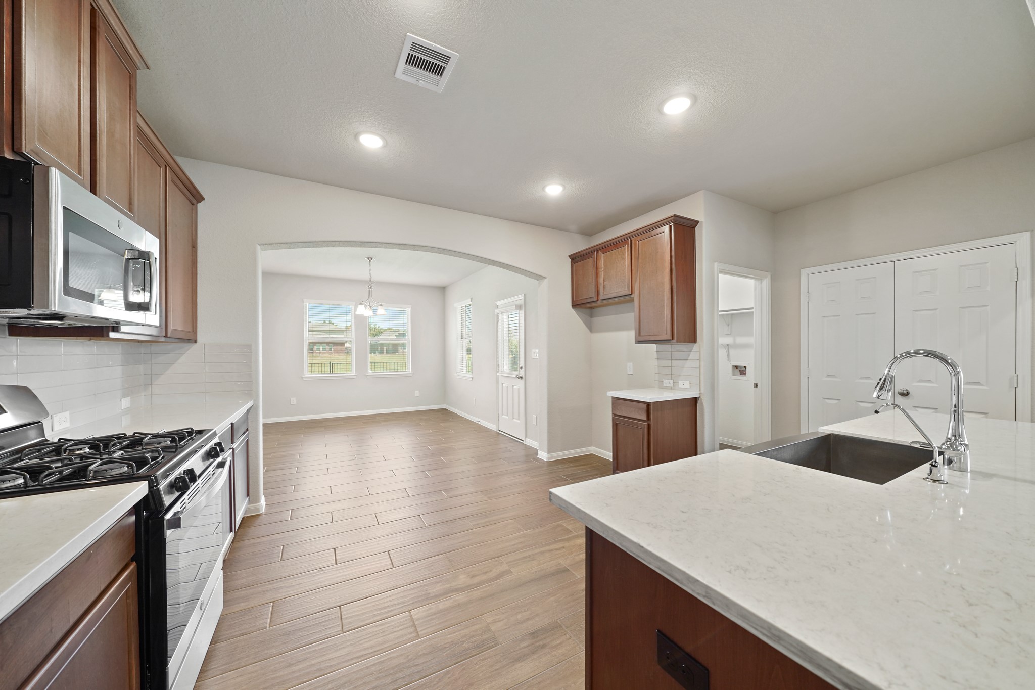 6010 Kolle Drive Rosenberg, TX 77471 - Photo 15 of 45 a kitchen with stainless steel appliances a refrigerator sink and stove