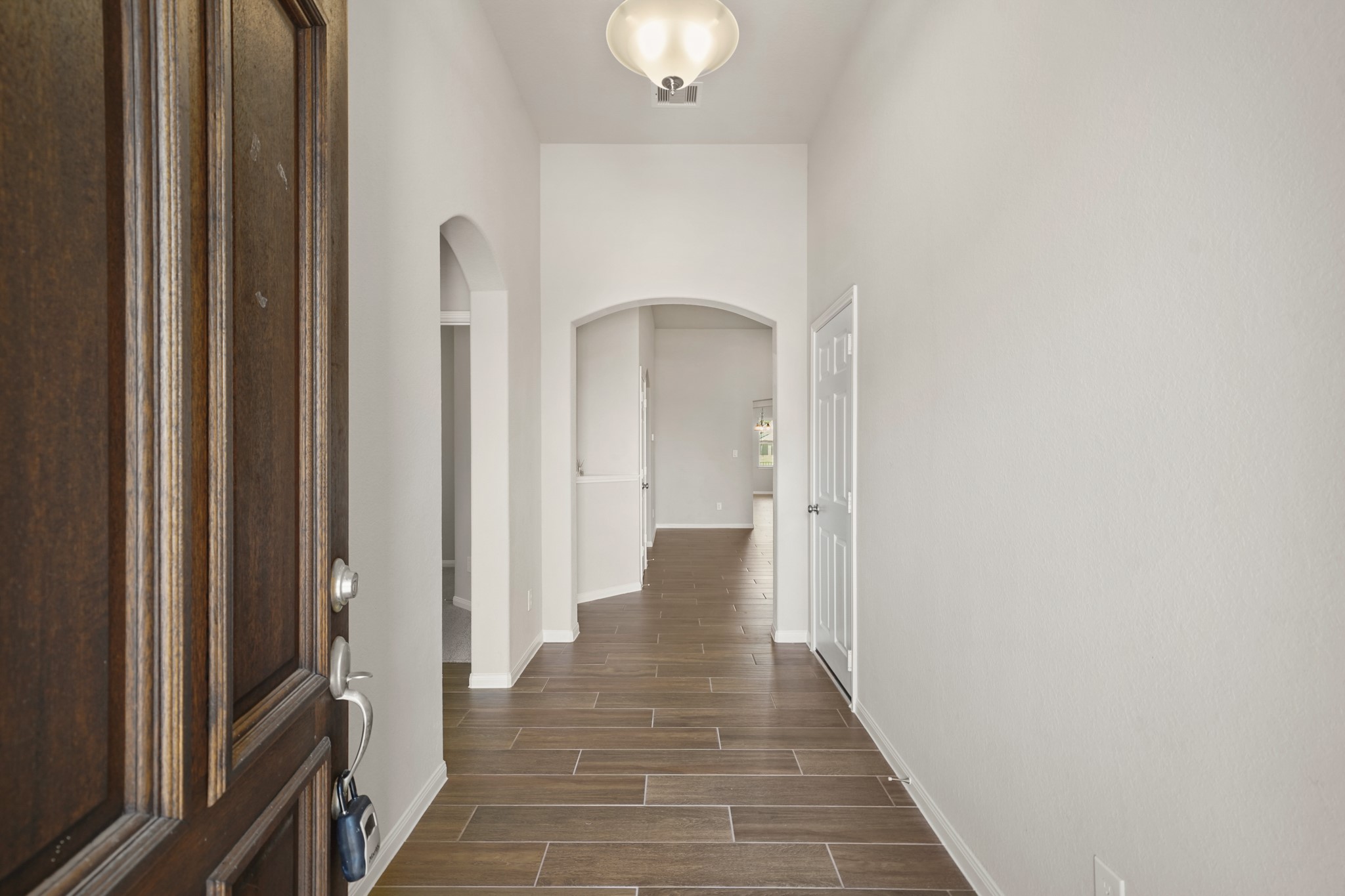 6010 Kolle Drive Rosenberg, TX 77471 - Photo 3 of 45 a view of a hallway with wooden floor and staircase