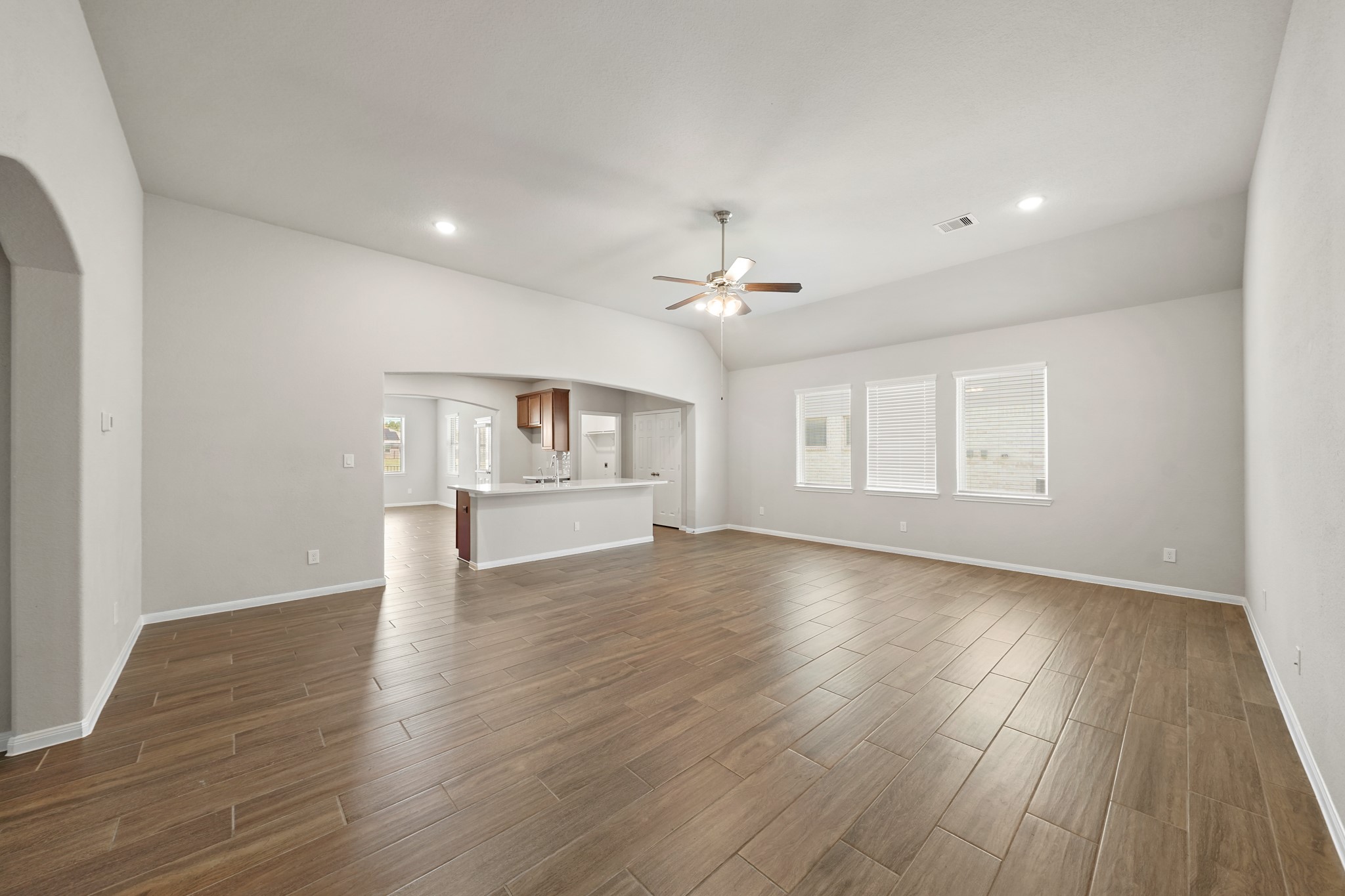 6010 Kolle Drive Rosenberg, TX 77471 - Photo 6 of 45 a view of an empty room with wooden floor and a window