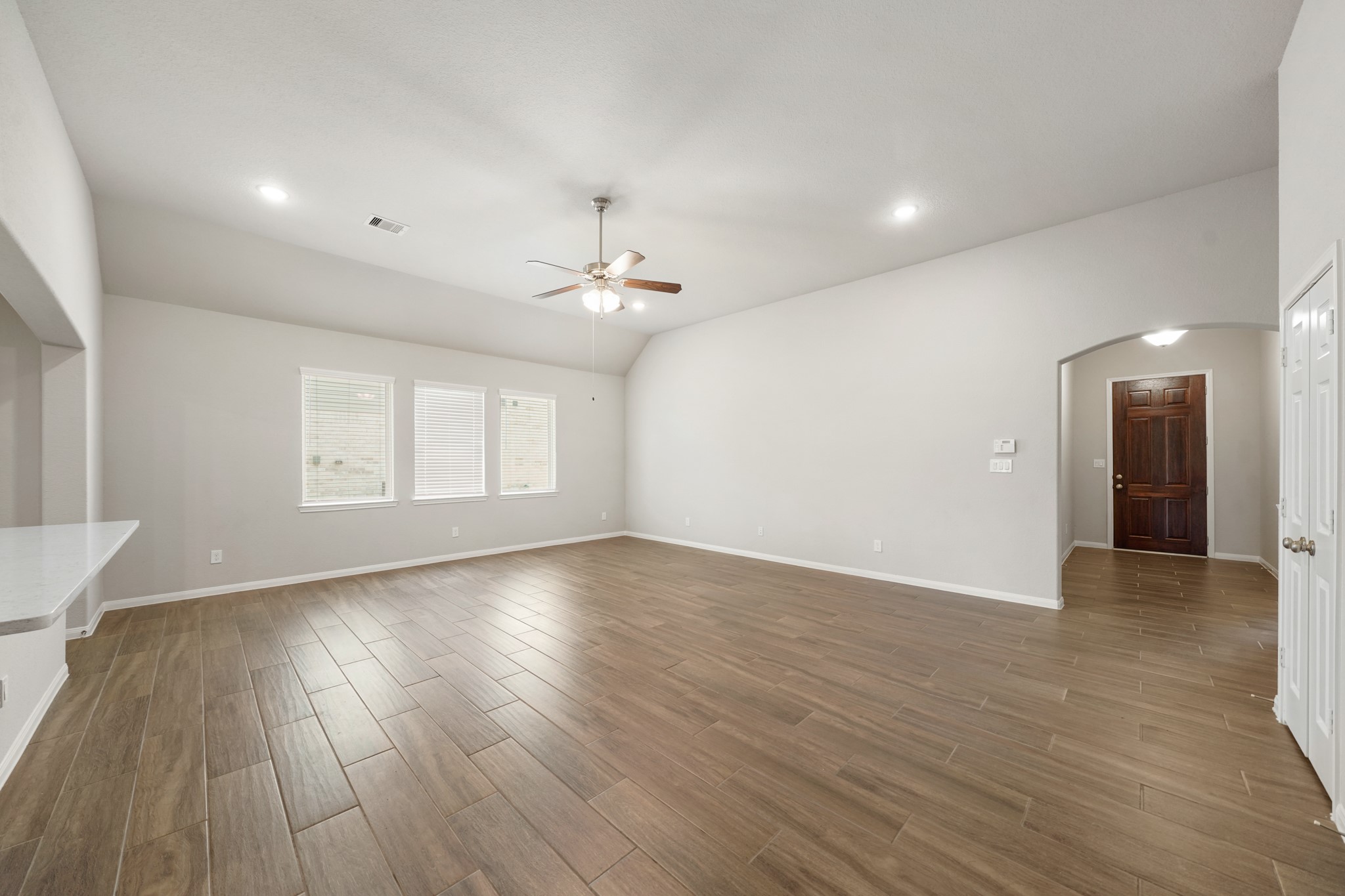 6010 Kolle Drive Rosenberg, TX 77471 - Photo 8 of 45 a view of an empty room with wooden floor and a window