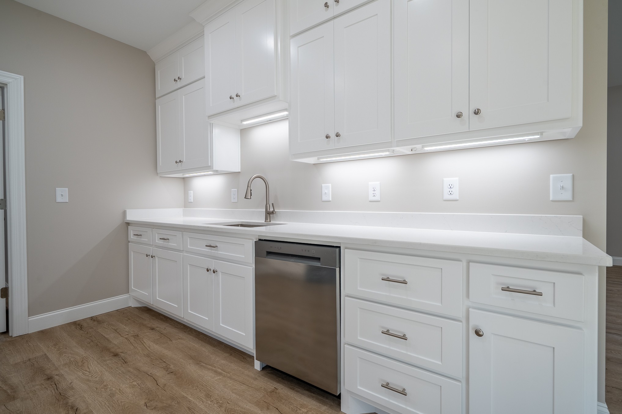 32 Periwinkle Path Leoma, TN 38468 - Photo 15 of 28 a kitchen with cabinets appliances a sink and dishwasher with wooden floor