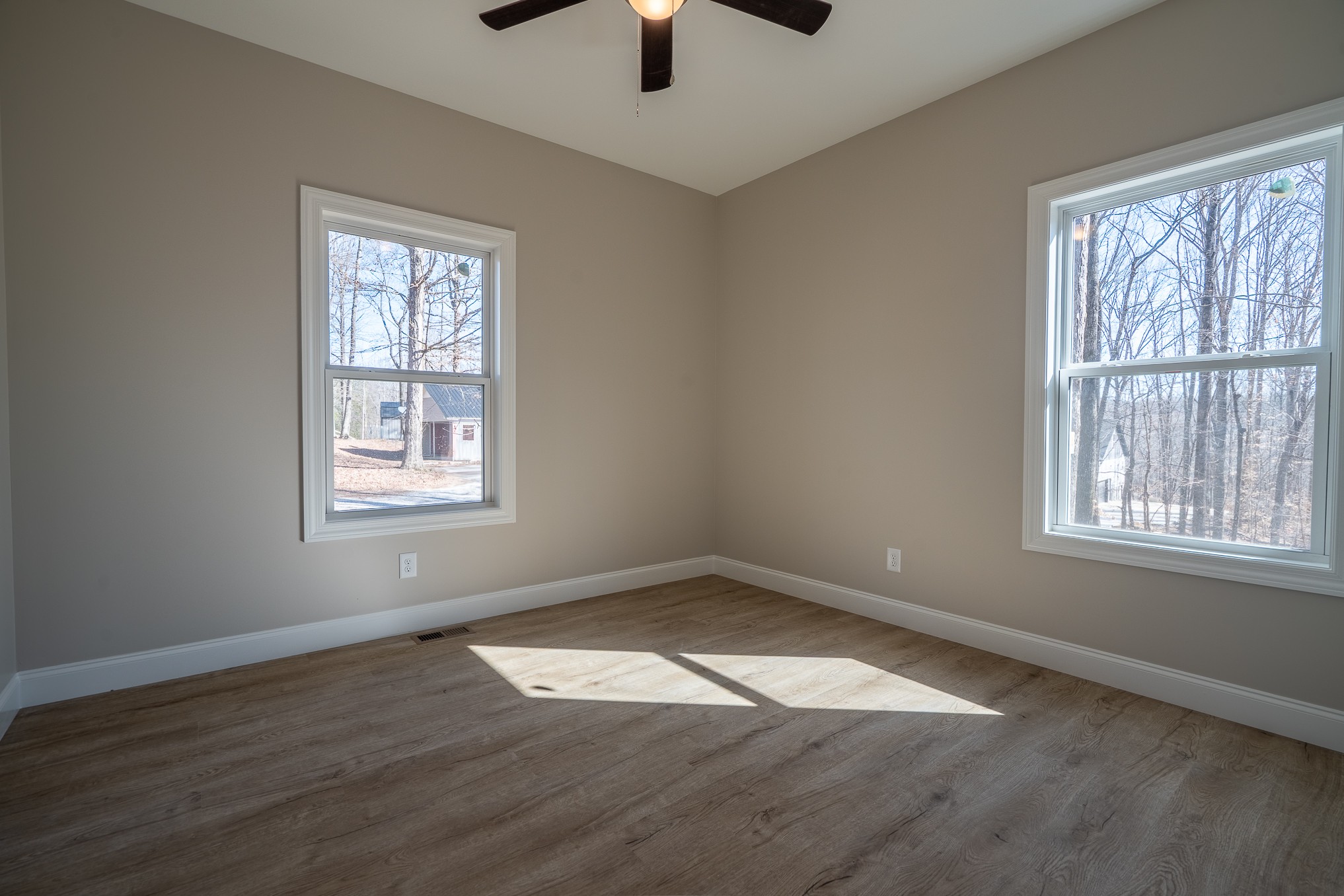 32 Periwinkle Path Leoma, TN 38468 - Photo 19 of 28 an empty room with wooden floor chandelier fan and windows