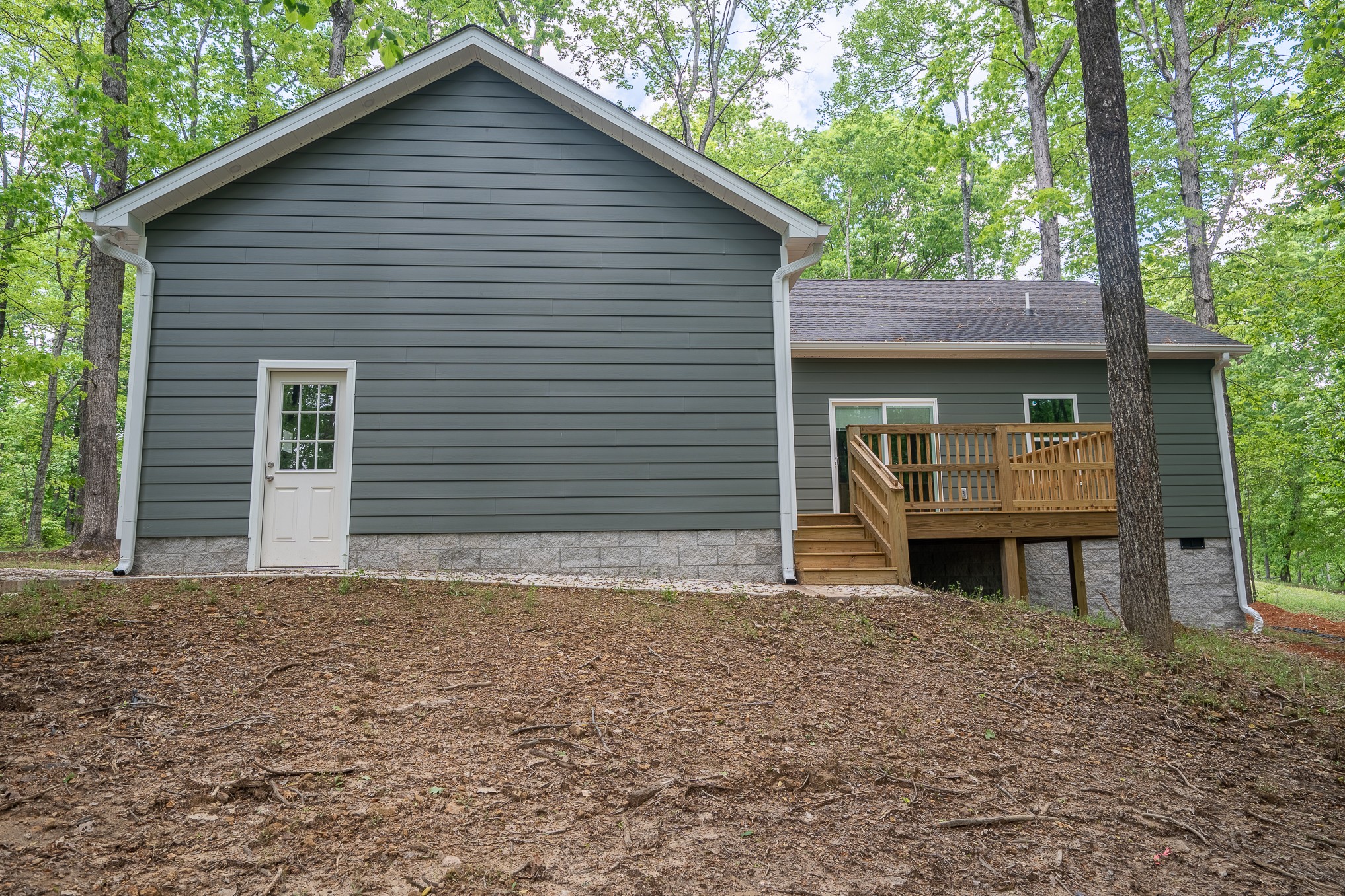 32 Periwinkle Path Leoma, TN 38468 - Photo 5 of 28 a front view of a house with a yard and garage