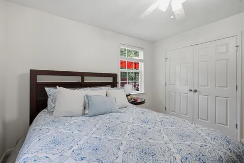 a bedroom with a bed and a window
