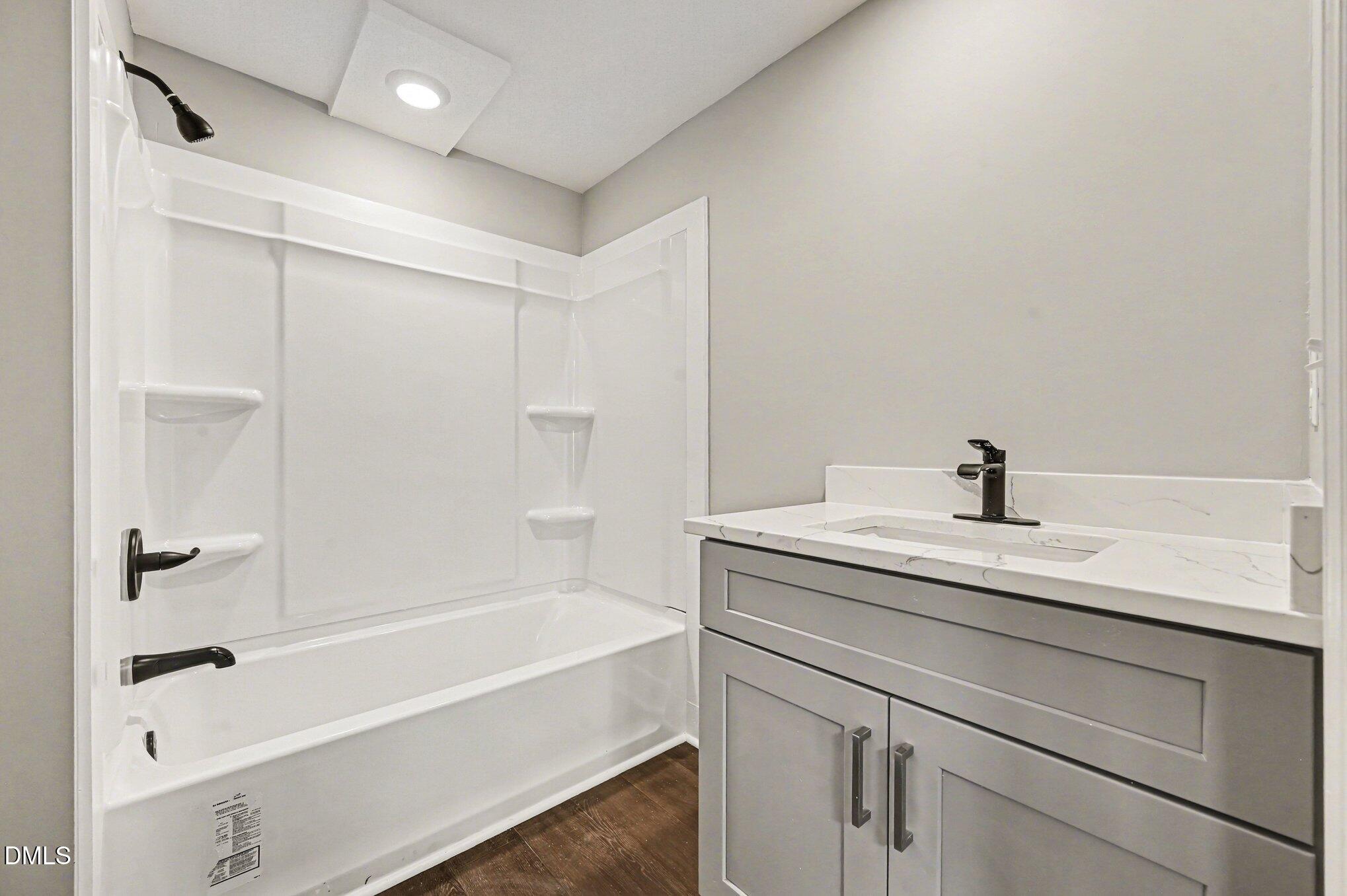 1325 Charlie Carr Road Roxboro, NC 27574 - Photo 26 of 31 a bathroom with a bathtub shower sink vanity and a toilet