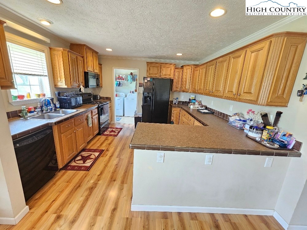 459 Edwards Road Ennice, NC 28623 - Photo 11 of 36 a large kitchen with lots of counter space and wooden floor