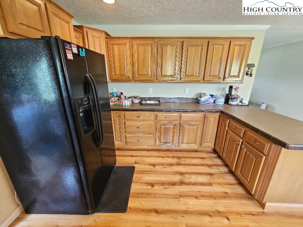 459 Edwards Road Ennice, NC 28623 - Photo 14 of 36 a kitchen with granite countertop a refrigerator a sink and dishwasher