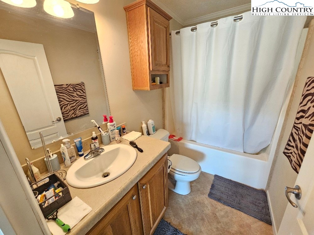 459 Edwards Road Ennice, NC 28623 - Photo 19 of 36 a bathroom with a sink toilet and shower