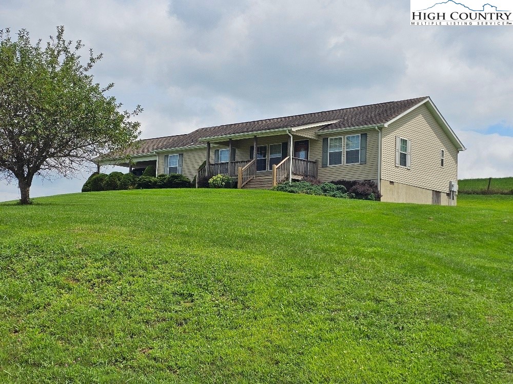 459 Edwards Road Ennice, NC 28623 - Photo 2 of 36 a front view of house with yard and green space