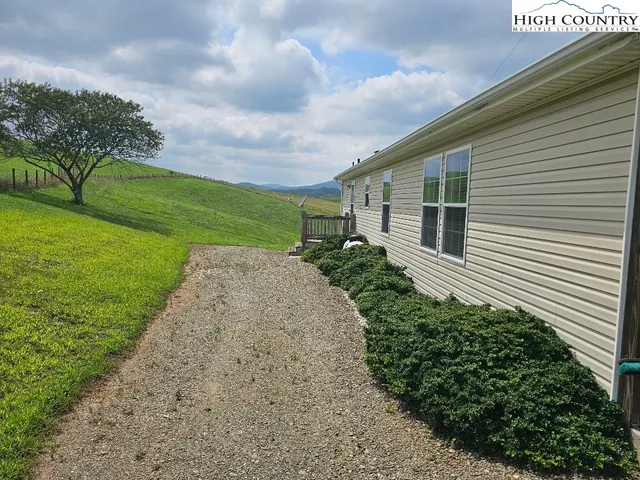 a view of a house with a yard and garage