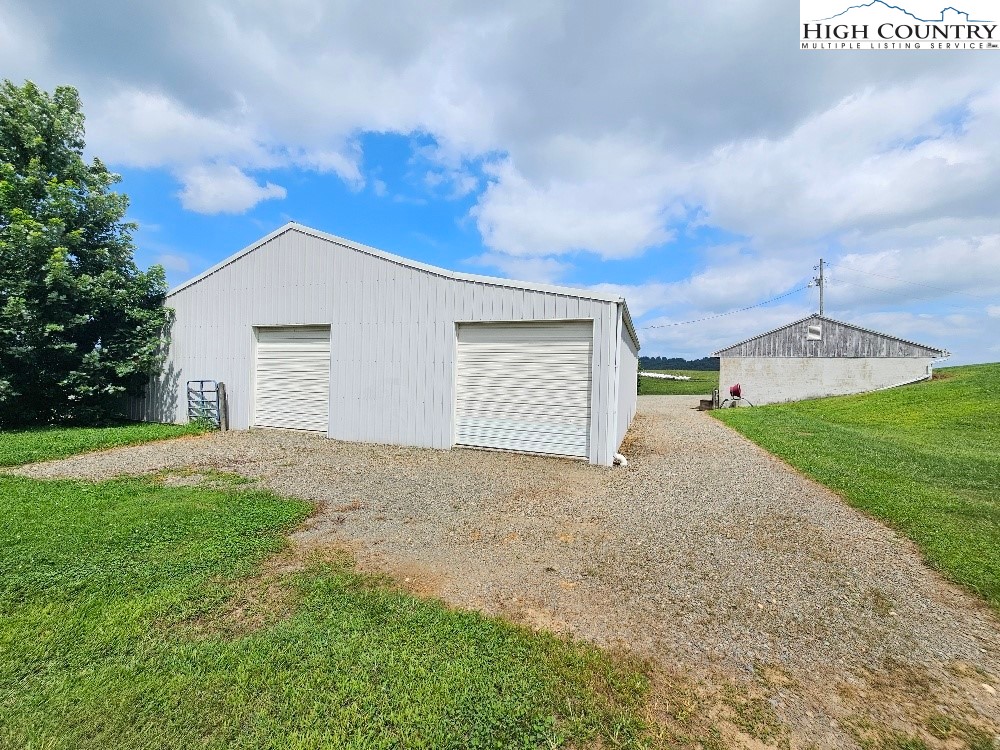 459 Edwards Road Ennice, NC 28623 - Photo 23 of 36 a view of a house with a yard and garage