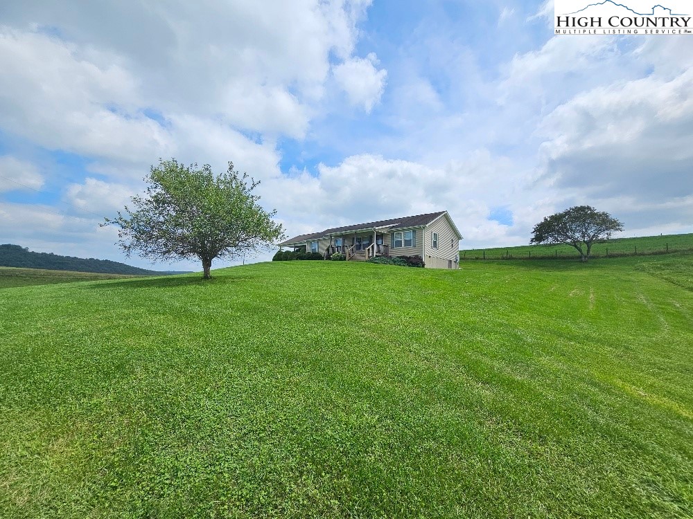 459 Edwards Road Ennice, NC 28623 - Photo 3 of 36 a view of a field of grass and trees