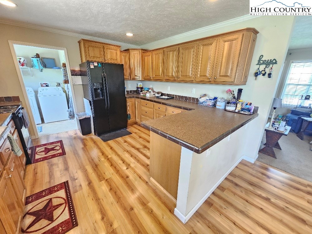 459 Edwards Road Ennice, NC 28623 - Photo 10 of 36 a view of a kitchen with fridge and workspace