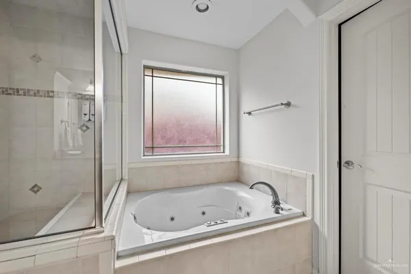 a bathroom with a tub and a shower
