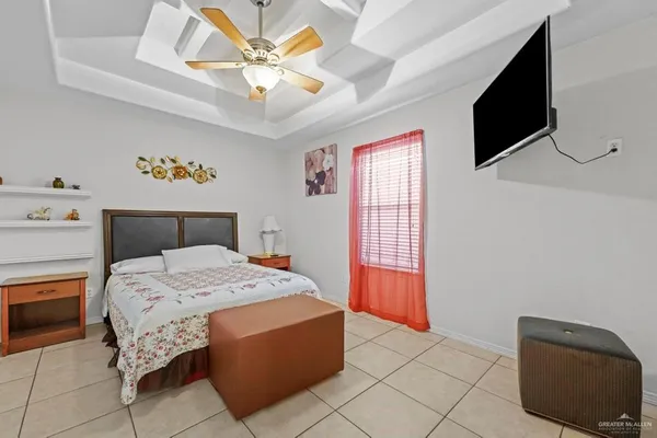 a bedroom with a bed and a television