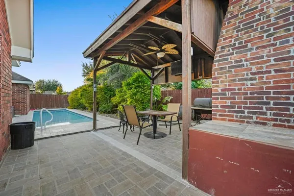 a view of a patio with table and chairs potted plants