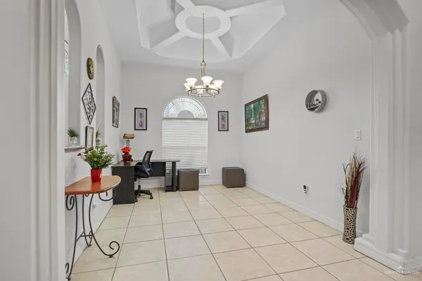 a view of a dining room with furniture and a chandelier fan