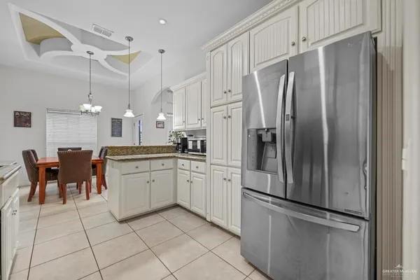 a kitchen with stainless steel appliances a refrigerator sink and cabinets