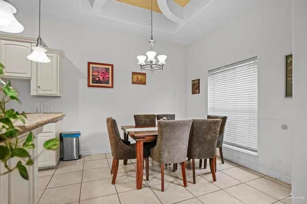 a view of a dining room with furniture and chandelier