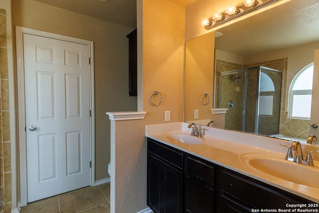 a bathroom with a double vanity sink and a mirror